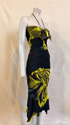 the mannequin is wearing a black and yellow dress with yellow flowers