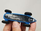 a person holding a small blue toy car in their hand