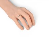 a close up of a person ' s hand with a ring on it
