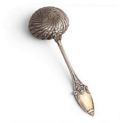 a close up of a spoon on a white surface
