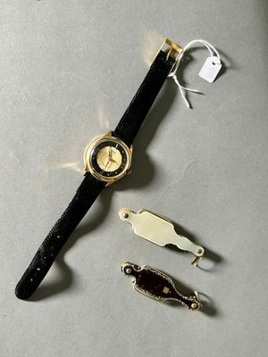 a watch that is laying on a table next to other items