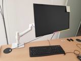 a keyboard and mouse on a desk with a monitor