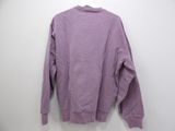 a purple sweatshirt hanging on a hanger against a white wall