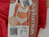 someone is holding up a red bra with a qr code attached to it