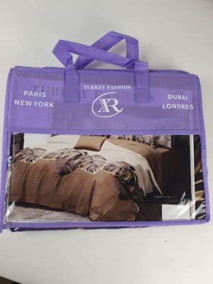the purple bag has a picture of a bed and pillows on it