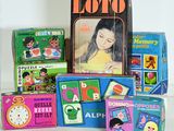 a lot of children ' s books and toys sitting on a table
