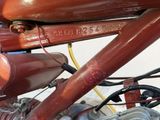 a close up of a motorcycle engine with a red cover