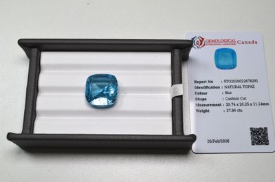 a blue diamond in a black box on a white surface