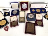 a lot of coins and medals on display on a table