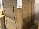 a stack of cardboard sitting on a pallet in a warehouse