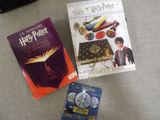 two harry potter books are sitting on a table next to a purse