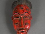 an image of a red mask with horns on a gray background