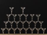 an assortment of wine glasses on a wooden table against a black background