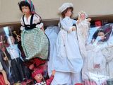 many dolls in a box that are sitting on a table