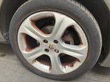 a dirty tire on the side of a car