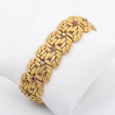 a close up of a gold bracelet on a white napkin