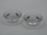 pair of clear glass ashtrays on a white surface
