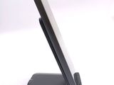 a cell phone sitting on a stand on a white surface