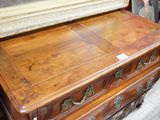 a wooden dresser with a mirror on top of it