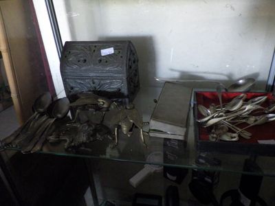 a glass table with silverware on it in a room