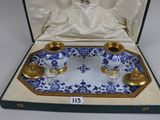 a blue and white tray with two cups on it