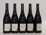 six bottles of red wine are lined up on a table