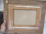 a person holding up a picture frame with a picture in it