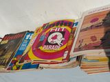 a lot of magazines on a bed with a shadow of a person