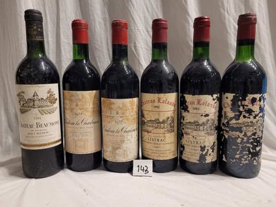 six bottles of red wine are lined up on a table