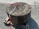 a large rock sitting on the ground next to a truck