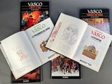 several books are sitting on top of a table next to each other