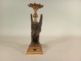 a gold candle holder with a bird on it