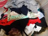 a laundry basket full of clothes on the floor