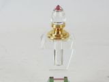 clear glass perfume bottle with a gold base and a red top