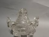 a small glass bowl with a lid on a table