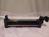 a black and yellow printer unit sitting on a plastic bag
