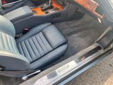 the interior of a car with the door open and the seat up