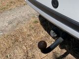 a ball stuck in the bumper of a boat on the grass