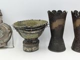 three different types of vases and a bottle on a white surface