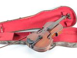 a violin that is sitting in a case on the ground