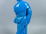 blue statue of a man holding a baby in his arms