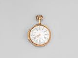 a gold pocket watch with roman numerals on the face