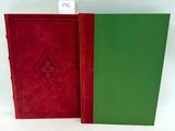 two red and green books sitting next to each other on a white surface