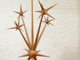 a wooden sculpture of a star on a shelf