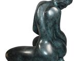 sculpture of a seated male figure on a white background
