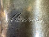 a silver vase with a name engraved on it