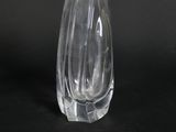 a clear glass vase sitting on top of a black table