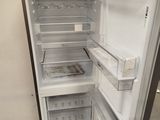 an open refrigerator that is sitting on a wooden pallet