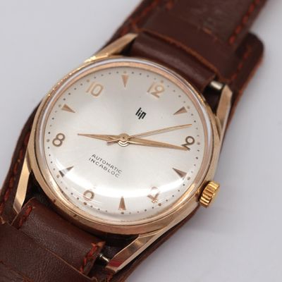 an image of a close up of a wrist watch on a white surface