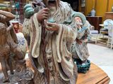 statue of a man with a goat and a goat on a table in a store